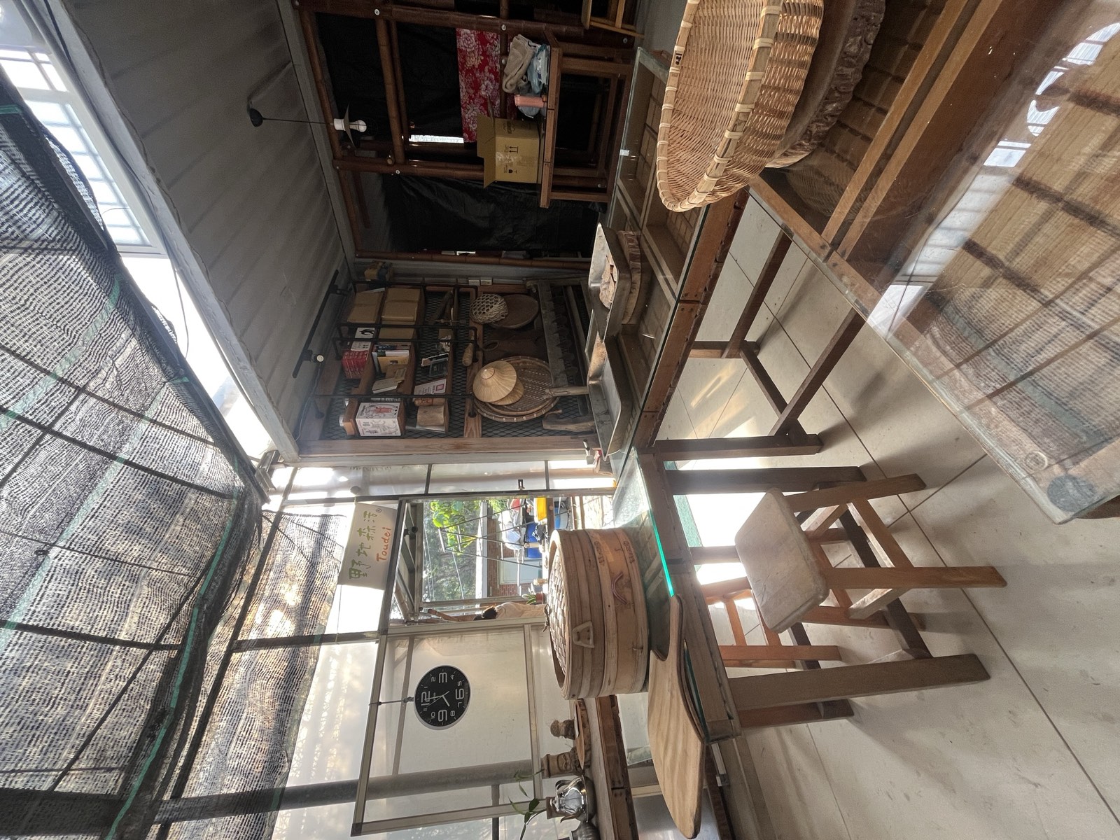 Traditioneller taiwanesischer Laden: Holzmöbel und Korbwaren, Lehmwand im Hintergrund